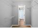 A walk-in closet with built-in shelving that leads to a full bathroom at 213 Summerwalk Cir, Chapel Hill, NC 27517