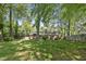 The backyard has a well maintained grass lawn, mature trees, and is mostly shaded at 215 Westridge Dr, Raleigh, NC 27609