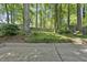 A backyard that is surrounded by mature trees, with a shed at 215 Westridge Dr, Raleigh, NC 27609