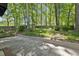 A backyard that has a shed, patio and is surrounded by mature trees at 215 Westridge Dr, Raleigh, NC 27609