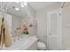 Bathroom with marble vanity, decorative mirror, fresh flowers, and neutral paint at 215 Westridge Dr, Raleigh, NC 27609