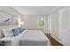 Bedroom with light colored walls, wood floors, a window and a comfy comforter at 215 Westridge Dr, Raleigh, NC 27609