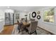 Bright dining room with decorative accents and updated stainless refrigerator off the kitchen at 215 Westridge Dr, Raleigh, NC 27609