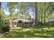Charming brick home featuring a cozy backyard, and mature trees at 215 Westridge Dr, Raleigh, NC 27609