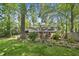 Charming brick home featuring manicured landscaping, a cozy backyard, and mature trees at 215 Westridge Dr, Raleigh, NC 27609