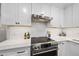 Modern kitchen features white cabinets and stainless steel appliances at 215 Westridge Dr, Raleigh, NC 27609