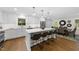 Open kitchen with island seating and modern light fixtures at 215 Westridge Dr, Raleigh, NC 27609