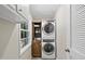 A convenient laundry room features stacked washer and dryer, and built-in storage at 215 Westridge Dr, Raleigh, NC 27609