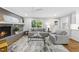 Cozy living room features a brick fireplace and neutral decor at 215 Westridge Dr, Raleigh, NC 27609