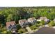 Neighborhood aerial showcases manicured lawns, mature trees, and a glimpse of a nearby lake at 221 Hammond Wood Pl, Morrisville, NC 27560