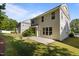View of a spacious backyard with grass, concrete patio and landscaping at 221 Hammond Wood Pl, Morrisville, NC 27560