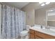Bathroom with a wood vanity, soft lighting, and a tub and shower combination at 221 Hammond Wood Pl, Morrisville, NC 27560