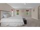Spacious bedroom featuring plush carpet, neutral walls, and multiple windows bringing in natural light at 221 Hammond Wood Pl, Morrisville, NC 27560