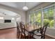 Formal dining area with natural light, a wooden table for six, and a partial view into the living room at 221 Hammond Wood Pl, Morrisville, NC 27560