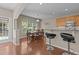 Bright dining area with a large window, wood floors, a decorative light fixture, and seating for six at 221 Hammond Wood Pl, Morrisville, NC 27560