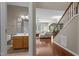 An entryway showcasing hardwood floors, a view into the living room, and a glimpse of a half bathroom at 221 Hammond Wood Pl, Morrisville, NC 27560