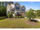 Two-story home with a manicured lawn and lush landscaping at 221 Hammond Wood Pl, Morrisville, NC 27560
