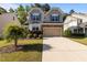Charming two-story home with a manicured lawn and two-car garage at 221 Hammond Wood Pl, Morrisville, NC 27560