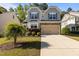 Charming two-story home with a manicured lawn and two-car garage at 221 Hammond Wood Pl, Morrisville, NC 27560