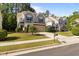 Two-story home with a manicured lawn and lush landscaping on a sunny day at 221 Hammond Wood Pl, Morrisville, NC 27560