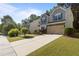 View of home with long driveway and manicured lawn at 221 Hammond Wood Pl, Morrisville, NC 27560