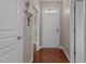 Inviting foyer with a decorative metal wall hanging and gleaming hardwood floors leads to the rest of the house at 221 Hammond Wood Pl, Morrisville, NC 27560