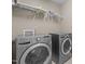 Laundry area featuring modern, stainless steel, front-loading machines at 221 Hammond Wood Pl, Morrisville, NC 27560