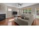 Comfortable living room with fireplace, ceiling fan, and lots of windows at 221 Hammond Wood Pl, Morrisville, NC 27560