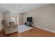 Spacious living room with wood floors, sofa and television at 221 Hammond Wood Pl, Morrisville, NC 27560