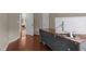 A home office setup with a view of the hallway, showcasing hardwood floors and neutral walls at 221 Hammond Wood Pl, Morrisville, NC 27560