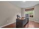 Home office featuring wood floors, a window with natural light, and a modern desk setup at 221 Hammond Wood Pl, Morrisville, NC 27560