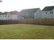 Wide backyard with green grass and a tall wooden fence, offering privacy from other houses at 222 Oak Branch Trl, Garner, NC 27529
