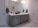 Bathroom with double sink vanity, light countertop, and neutral gray cabinets at 222 Oak Branch Trl, Garner, NC 27529