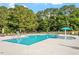 Large community pool with clear water, lounge chairs, umbrellas, and ample deck space at 222 Oak Branch Trl, Garner, NC 27529