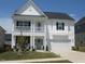 Charming two-story home with a covered porch and well-maintained lawn at 222 Oak Branch Trl, Garner, NC 27529
