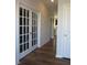Elegant hallway with hardwood floors and double French doors at 222 Oak Branch Trl, Garner, NC 27529
