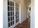 Elegant hallway with hardwood floors and double French doors at 222 Oak Branch Trl, Garner, NC 27529