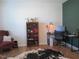 Cozy home office with a desk, bookshelf, and comfortable chair at 222 Oak Branch Trl, Garner, NC 27529