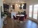 Open-concept kitchen and dining area features a quartz countertop island, black cabinets, and modern decor at 222 Oak Branch Trl, Garner, NC 27529