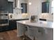 The kitchen showcases black cabinets, stainless steel appliances, white herringbone backsplash, and a quartz countertop island with seating at 222 Oak Branch Trl, Garner, NC 27529