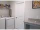Laundry room with washer, dryer, and granite countertop folding space at 222 Oak Branch Trl, Garner, NC 27529