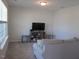 Bright living room showcasing neutral carpet, modern furniture and large windows providing great natural lighting at 222 Oak Branch Trl, Garner, NC 27529
