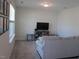 Bright living room showcasing neutral carpet, modern furniture and large windows providing great natural lighting at 222 Oak Branch Trl, Garner, NC 27529