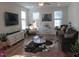 Bright living room with hardwood floors, modern decor, and comfortable seating arrangement at 222 Oak Branch Trl, Garner, NC 27529