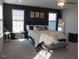 Sunlit main bedroom features a dark accent wall and a sitting bench at 222 Oak Branch Trl, Garner, NC 27529