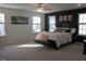 Spacious main bedroom with large windows and neutral decor with king bed at 222 Oak Branch Trl, Garner, NC 27529