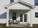 Charming covered porch with comfortable seating and a view of the landscaped yard at 222 Oak Branch Trl, Garner, NC 27529