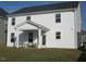 This home features a white exterior with dark trim and covered porch with outdoor seating for relaxing and entertaining at 222 Oak Branch Trl, Garner, NC 27529
