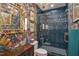 Stylish bathroom featuring vibrant floral wallpaper and a blue-tiled shower with glass door at 2306 Byrd St, Raleigh, NC 27608