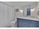 Cozy bathroom featuring a white marble counter, crystal light fixtures and decorative mirror at 2306 Byrd St, Raleigh, NC 27608